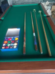 a green pool table with four cue balls on it at Arhh castle in Ginigathena