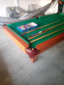 a green pool table sitting on top of a bed at Arhh castle in Ginigathena