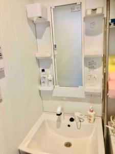 a bathroom with a sink and a mirror at Maison Lumière in Odawara +40 photos