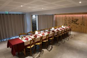 a conference room with a long table with red table cloth at Hotel du Haut du Roc Demi Pension Comprise in Basse-sur-le-Rupt +55 photos