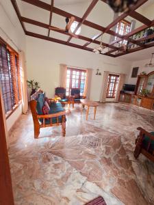 a large living room with a large marble floor at Spacious 3-Bedroom Private Villa in Mangalore - Ideal Getaway for Family and Friends in Mangalore
