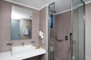 a bathroom with a shower and a sink and a shower at Lindos Portes Blue in Lindos
