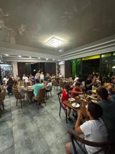 a group of people sitting at tables in a restaurant at DeltaHotel in Ureki