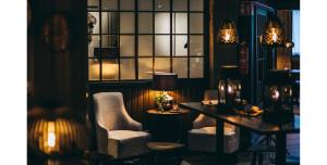 a room with two chairs and a table and a lamp at Lapland Hotels Kuopio in Kuopio