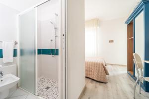 a bathroom with a shower and a sink at Amadei Hotel Promenade in Pesaro +48 photos
