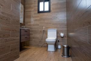 a bathroom with a toilet and a window at Fallsway Palms in Lusaka +5 photos