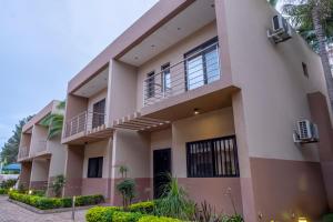 a large house with balconies and trees at Fallsway Palms in Lusaka
