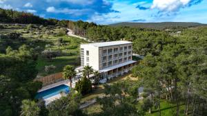 an aerial view of a hotel building with a swimming pool at Garrya Romo Hotel in Urla