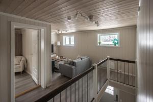 a living room with a couch and a chair at Skoglund privat Villa in Trysil