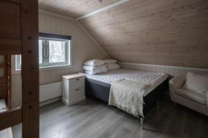 a small bedroom with a bed and a window at Skoglund privat Villa in Trysil