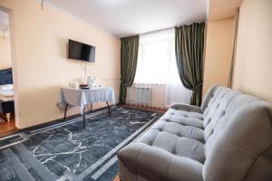 a living room with a couch and a table at Samal Resort and SPA in Taraz