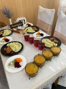 a table with many plates of food on it at Вілла Верховина in Skhidnitsa +19 photos