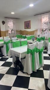 a room with green and white tables and chairs at Вілла Верховина in Skhidnitsa