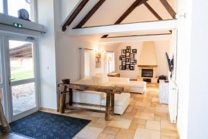 a living room with a couch and a table at Le grand gîte in Souvigny