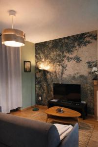 a living room with a couch and a table at Studio neuf équipé, confortable et au calme in Issoire