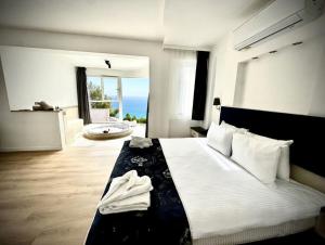 a bedroom with a bed with a view of the ocean at Azure Palm Resort in Oludeniz +60 photos