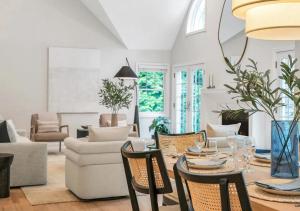 a living room with a table and chairs at Villa Montauk Mist in East Hampton