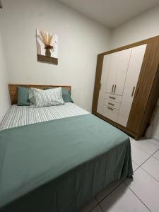 a bedroom with a large bed and a dresser at Apartment D Fuertevali in San Salvador +4 photos