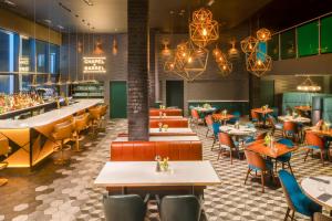 a restaurant with tables and chairs and a bar at Hotel Indigo Liverpool by IHG in Liverpool