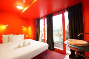 a hotel room with a large bed and a window at Hotel Not Hotel Rotterdam in Rotterdam