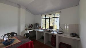 a room with a desk with a computer and a window at Chotlung BNB in Bijanbāri Bāzār