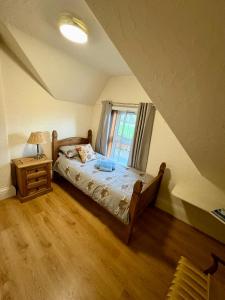 a bedroom with a bed and a window at Ythanview Hotel in Methlick