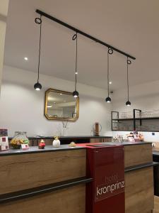a restaurant with a counter with a mirror at Hotel Kronprinz Garni in Minden