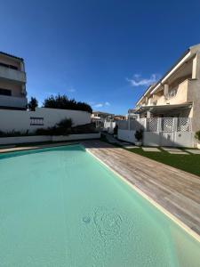 a swimming pool in front of a house at Appartamento Sardinia Escape in residence - Palau in Palau