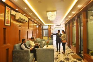 a group of people sitting in a lobby at Hotel Rajmahal Regency in Faridabad