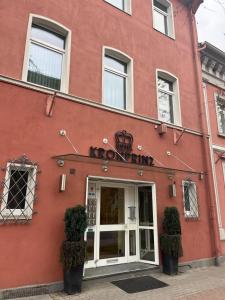 a red building with a sign that reads noontime at Hotel Kronprinz Garni in Minden +28 photos