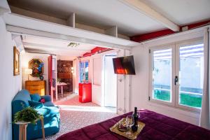 a living room with a blue couch and a window at Atelier Randagi al Pigneto 1&2 in Rome