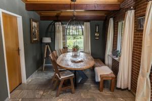 a dining room with a table and chairs and a window at Bij nr 5 Teuge in Terwolde