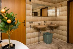 a bathroom with two sinks and a mirror at Bij nr 5 Teuge in Terwolde +26 photos