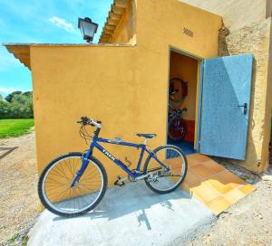 a blue bike parked in front of a building at Turisme Rural Mas Ramades in L'Estartit