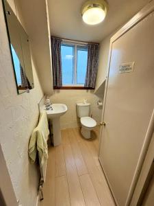 a bathroom with a toilet and a sink at Ythanview Hotel in Methlick