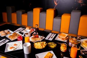 a table with plates of breakfast food on it at HF Fénix Music in Lisbon