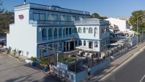 a blue and white building on the side of a street at Hotel Santa Eulália Bay - Adults Only in Albufeira