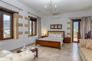 a bedroom with a bed and a couch at Villa Chrysseva in Plátanos