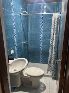 a bathroom with a toilet and a sink and a shower at The Cats Nail house in Cali +24 photos