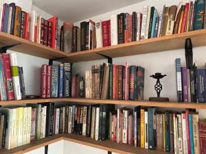 a book shelf filled with lots of books at The Cats Nail house in Cali