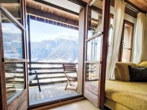 a room with a window with a view of a mountain at Apartment Aragon B48 by Interhome in Ernen