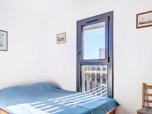 a bedroom with a bed and an open window at Apartment Horizon Marin-2 by Interhome in Lacanau-Océan
