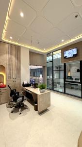 an office with a desk with a computer on it at Hotel Unicorn Althan, Surat in Surat