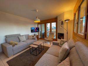 a living room with a couch and a table at Apartment Les Chouettes 11 by Interhome in Nendaz