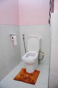 a bathroom with a leopard rug next to a toilet at EXCLUSIVE ANSO Homes GRA Ikeja 1 bed room in Ikeja