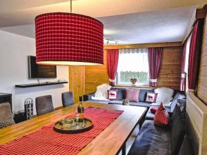 a living room with a couch and a table at Holiday Home Ötztal by Interhome in Oetz