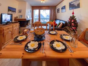 a wooden table with plates of food on top of it at Apartment Hauts de Nendaz BI3 by Interhome in Nendaz