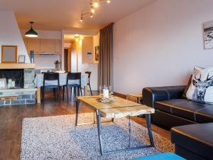 a living room with a couch and a table at Apartment Chaedoz 24-1 by Interhome in Nendaz
