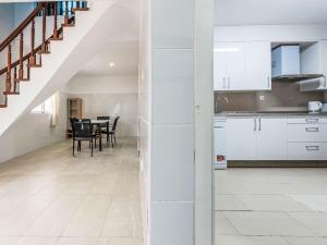 an open kitchen and dining room with white cabinets at Holiday Home Del Sol by Interhome in Salou