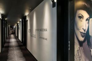 a hallway with posters of a woman on the wall at HF Fénix Music in Lisbon +17 photos